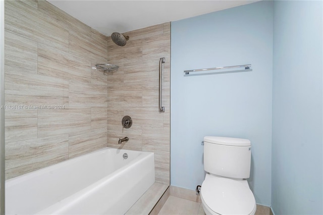 bathroom featuring tile patterned flooring, tiled shower / bath combo, and toilet