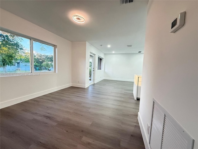 empty room with dark hardwood / wood-style flooring