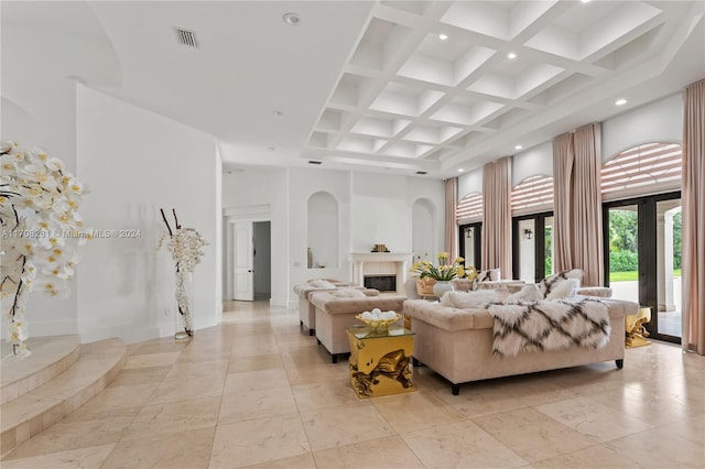 living room featuring beam ceiling, a towering ceiling, and coffered ceiling