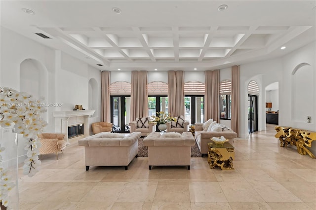 living room with beamed ceiling, a high ceiling, and coffered ceiling