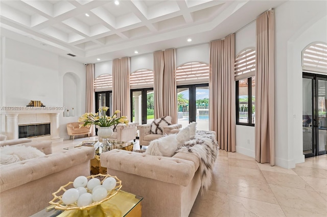 living room featuring french doors, coffered ceiling, a high ceiling, a high end fireplace, and beamed ceiling