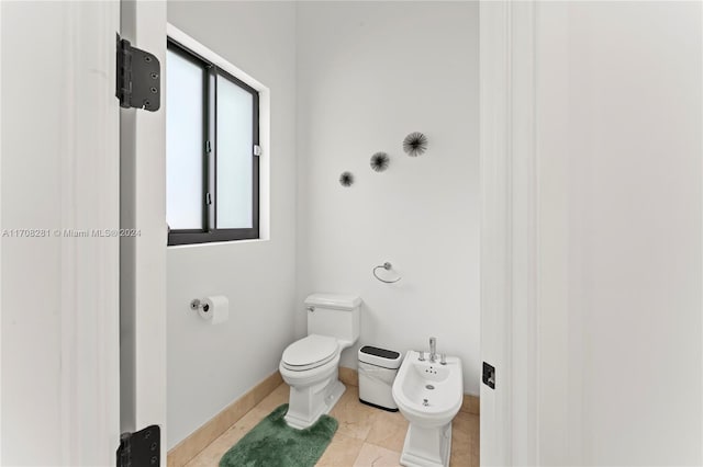 bathroom featuring tile patterned flooring, a bidet, and toilet