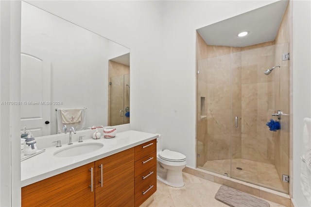 bathroom with tile patterned flooring, vanity, toilet, and an enclosed shower