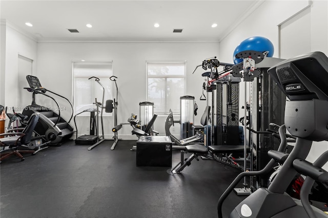 exercise room featuring crown molding