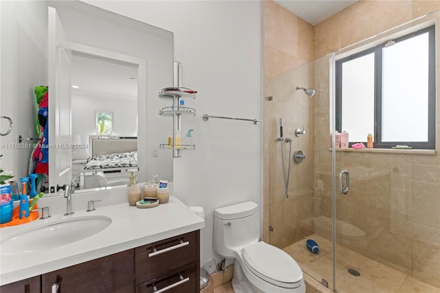 bathroom featuring vanity, a shower with shower door, and toilet