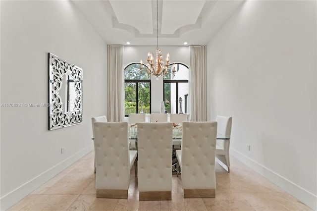 dining room featuring a tray ceiling and a notable chandelier