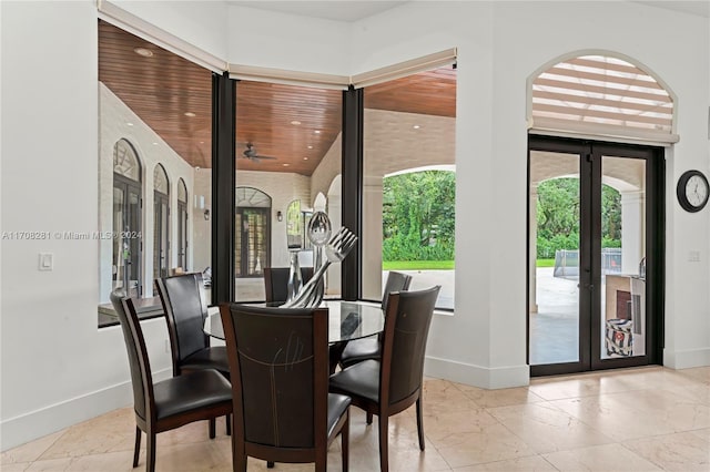 dining area featuring ceiling fan and french doors