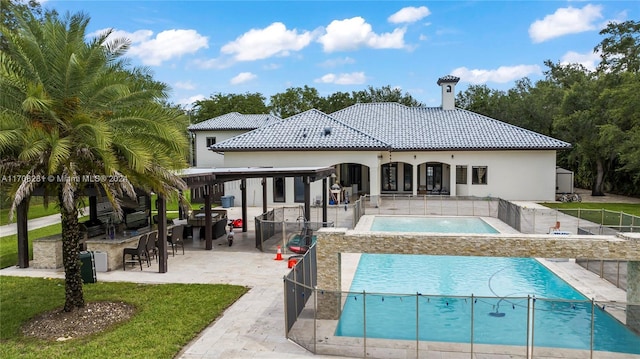 rear view of house with a bar, a patio, and a pool with hot tub