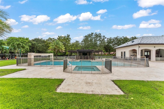 view of pool featuring a lawn and a patio area