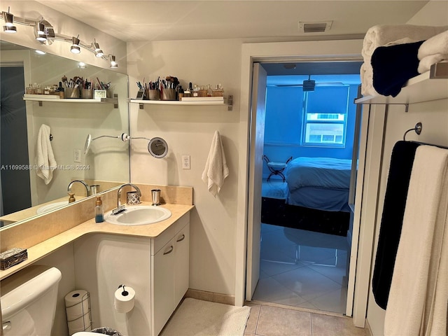 bathroom featuring tile patterned flooring, vanity, and toilet