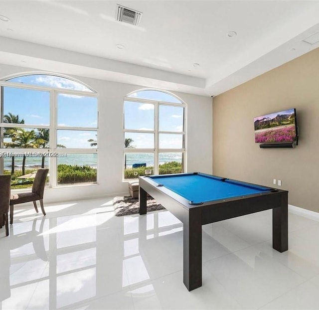 game room featuring light tile patterned flooring, a water view, and pool table