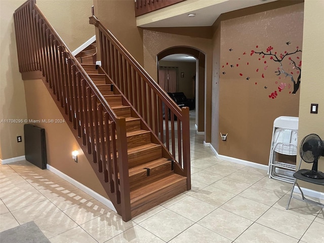 staircase featuring tile patterned flooring