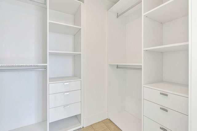 spacious closet with light tile patterned floors