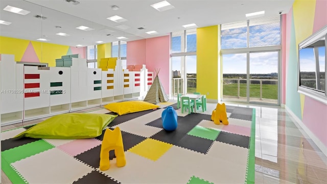 game room featuring a towering ceiling