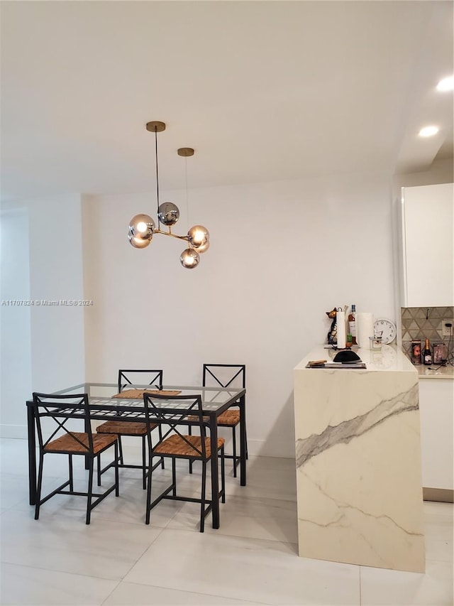 dining room featuring light tile patterned floors and an inviting chandelier