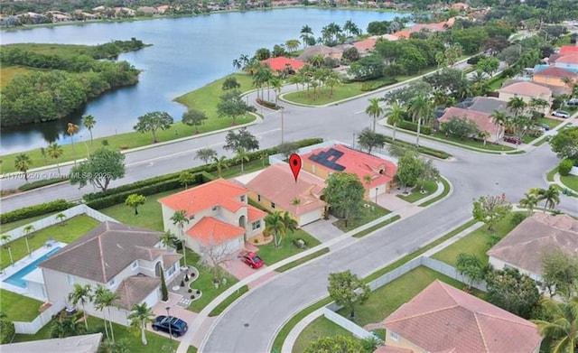 birds eye view of property with a water view