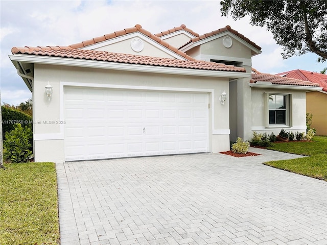 mediterranean / spanish home featuring a front yard and a garage