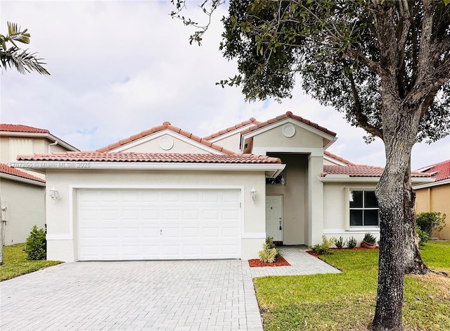 mediterranean / spanish house featuring a front yard and a garage