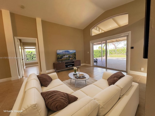 tiled living room with a wealth of natural light and vaulted ceiling