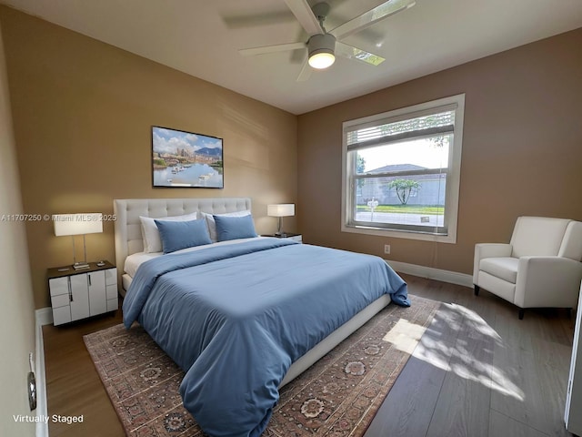 bedroom featuring ceiling fan and dark hardwood / wood-style flooring