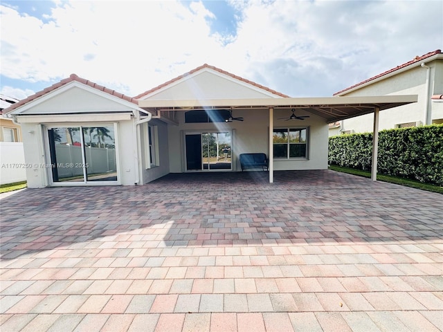 exterior space with ceiling fan and a patio