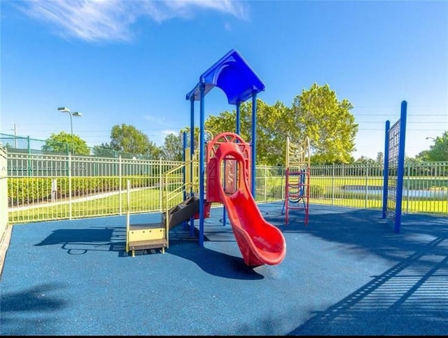 view of playground featuring a water view