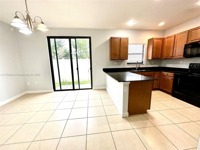 kitchen featuring black appliances, sink, light tile patterned floors, decorative light fixtures, and kitchen peninsula