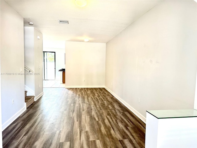 empty room with dark wood-type flooring