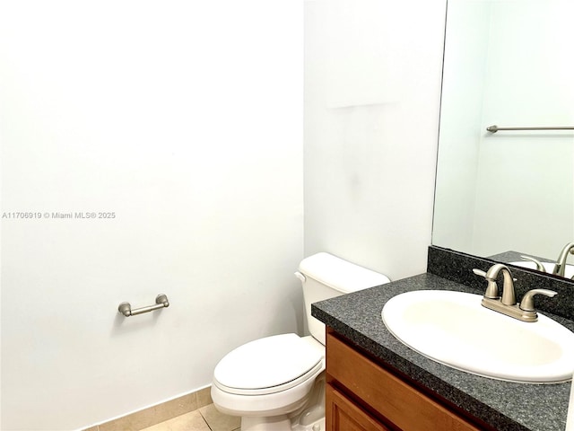 bathroom featuring tile patterned flooring, vanity, and toilet