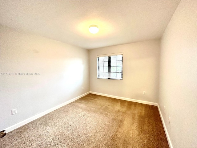 carpeted empty room with a textured ceiling