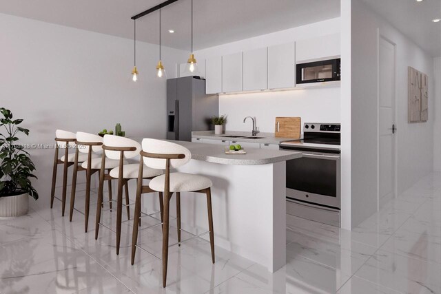 kitchen featuring pendant lighting, white cabinets, sink, a kitchen island, and stainless steel appliances