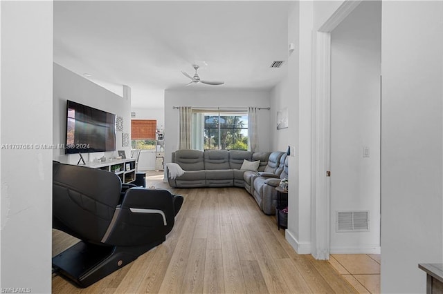 living room featuring light wood-type flooring and ceiling fan