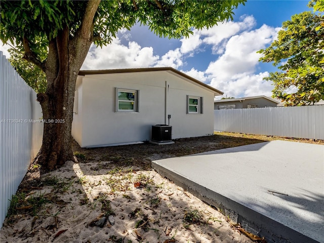 rear view of property with a patio area and central air condition unit