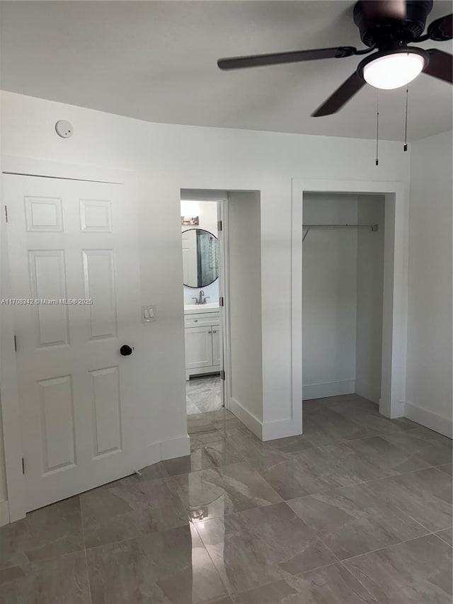 unfurnished bedroom featuring connected bathroom and ceiling fan