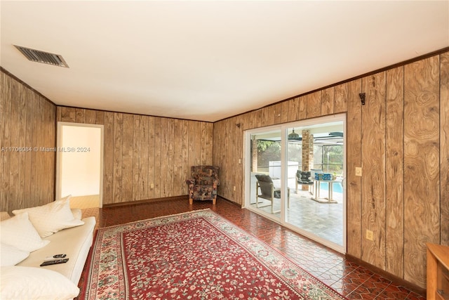 unfurnished living room with wood walls