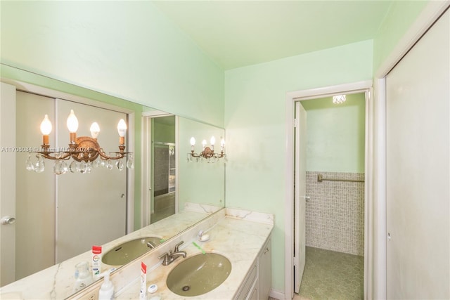 bathroom featuring vanity, an inviting chandelier, and tile walls