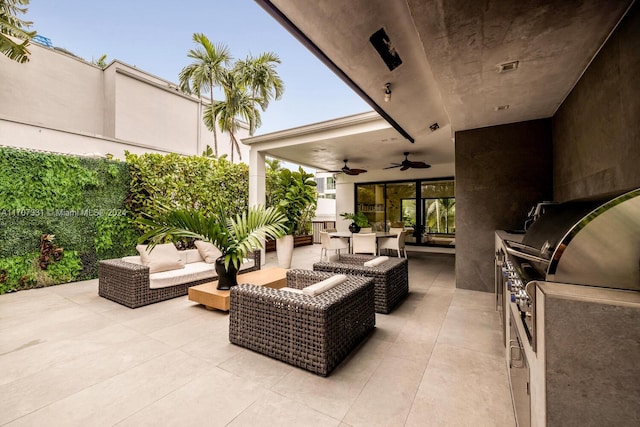 view of patio / terrace featuring outdoor lounge area, ceiling fan, and exterior kitchen