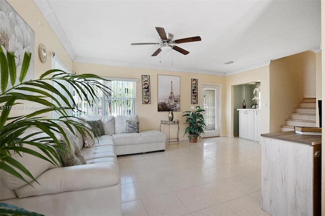 living room with ceiling fan and ornamental molding