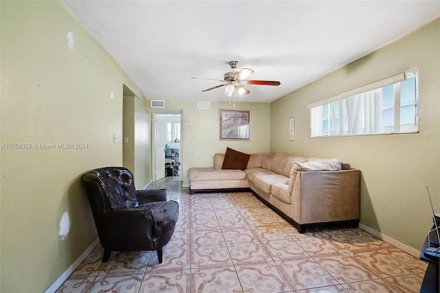 tiled living room with ceiling fan