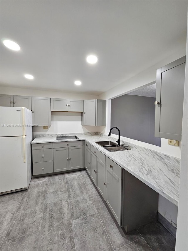 3600 NE 170th St Unit 402, North Miami Beach, FL 33160 - kitchen featuring freestanding refrigerator, gray cabinets, black electric stovetop, and recessed lighting