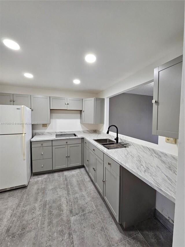 3600 NE 170th St Unit 402, North Miami Beach, FL 33160 - kitchen with freestanding refrigerator, gray cabinetry, black electric stovetop, and recessed lighting