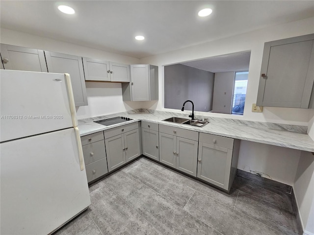 3600 NE 170th St Unit 402, North Miami Beach, FL 33160 - kitchen with freestanding refrigerator, gray cabinetry, black electric cooktop, light stone countertops, and recessed lighting