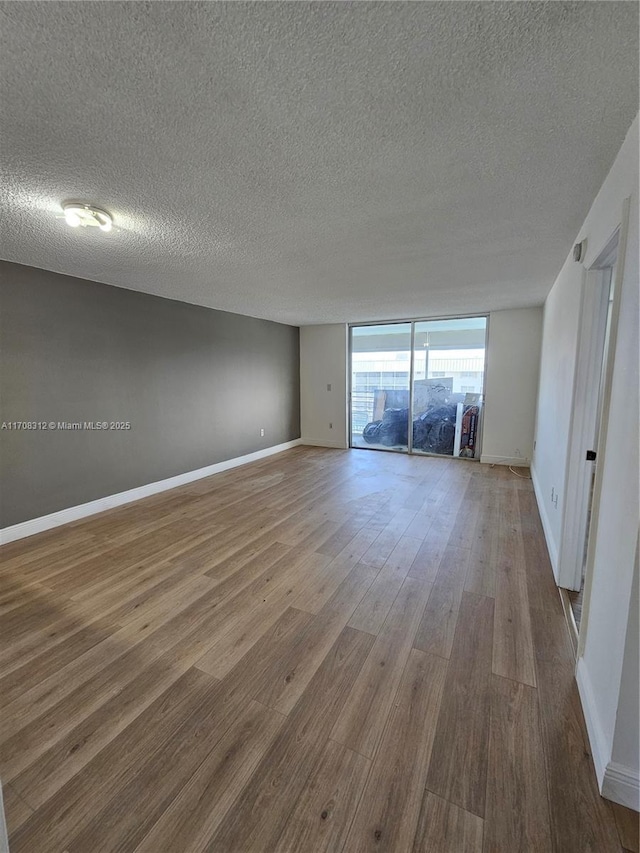 3600 NE 170th St Unit 402, North Miami Beach, FL 33160 - spare room with a textured ceiling and wood finished floors