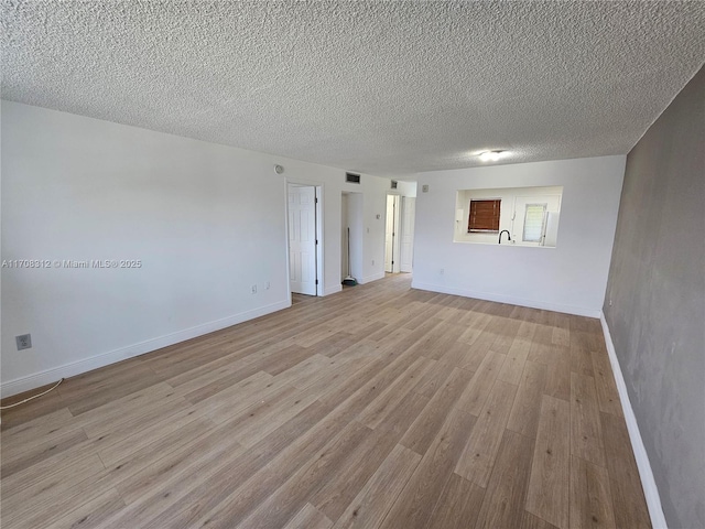 3600 NE 170th St Unit 402, North Miami Beach, FL 33160 - unfurnished room with light wood-style flooring and a textured ceiling