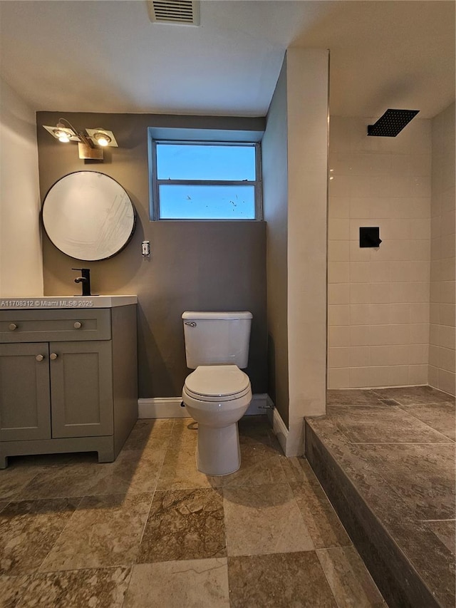 3600 NE 170th St Unit 402, North Miami Beach, FL 33160 - bathroom featuring vanity, tiled shower, and stone finish floors