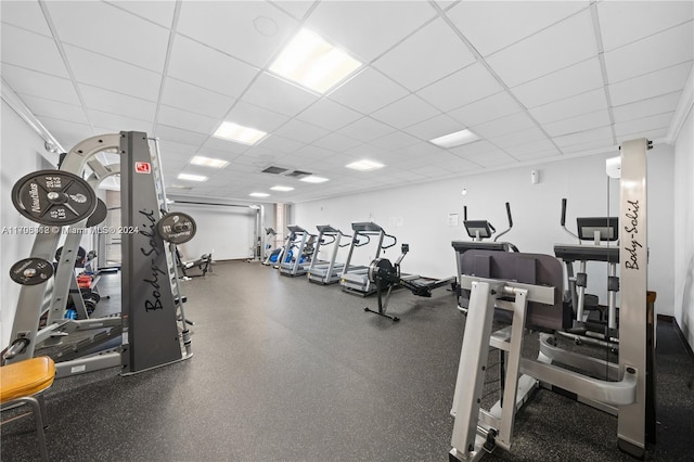 gym featuring a paneled ceiling