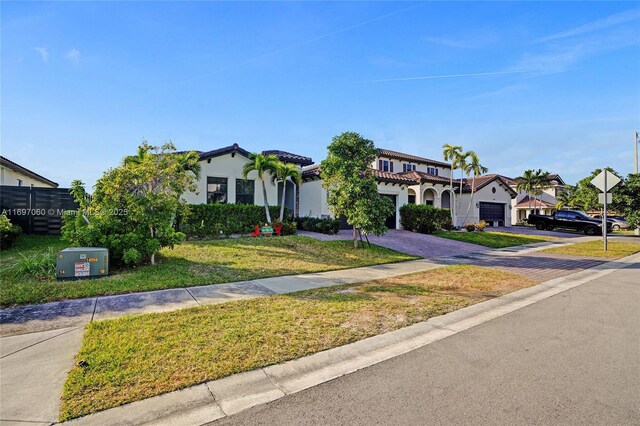 mediterranean / spanish-style house with a front yard