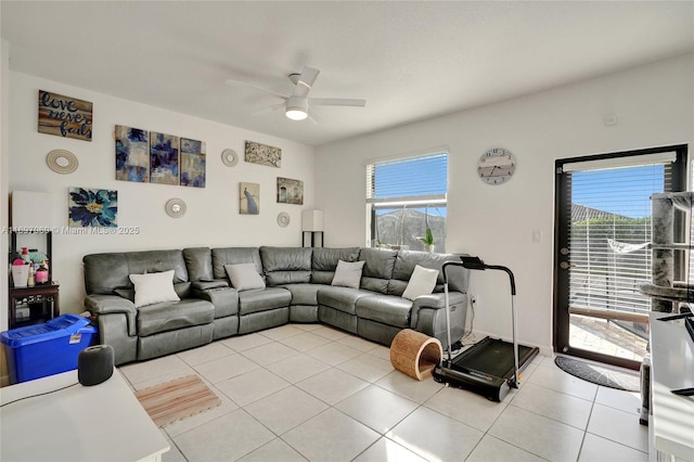 living room with light tile patterned floors, a healthy amount of sunlight, and ceiling fan