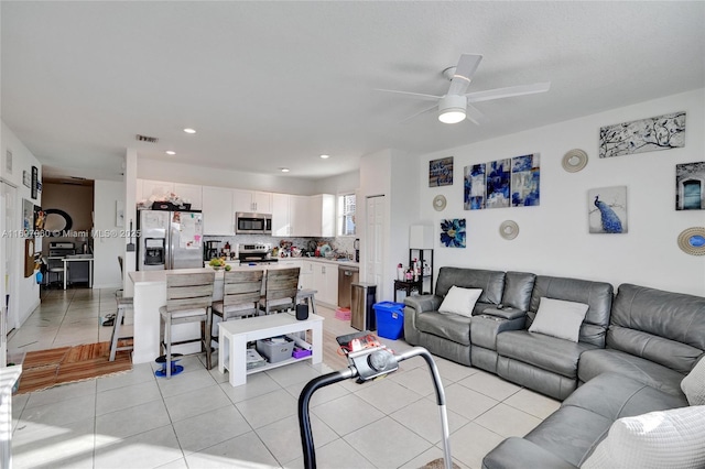 living area featuring light tile patterned floors, recessed lighting, a ceiling fan, and visible vents