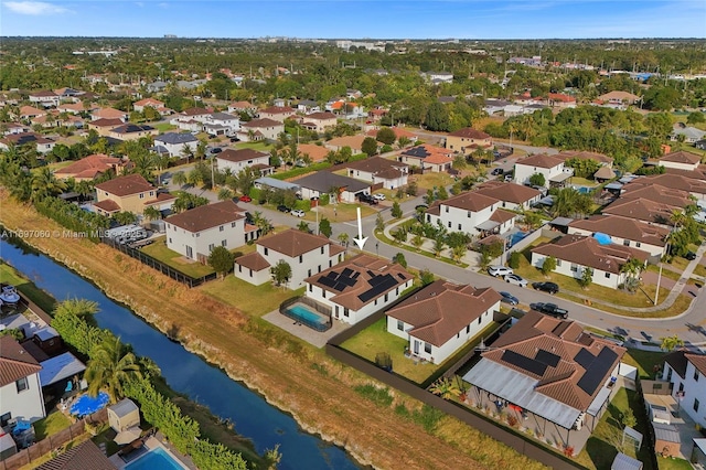 birds eye view of property with a residential view and a water view